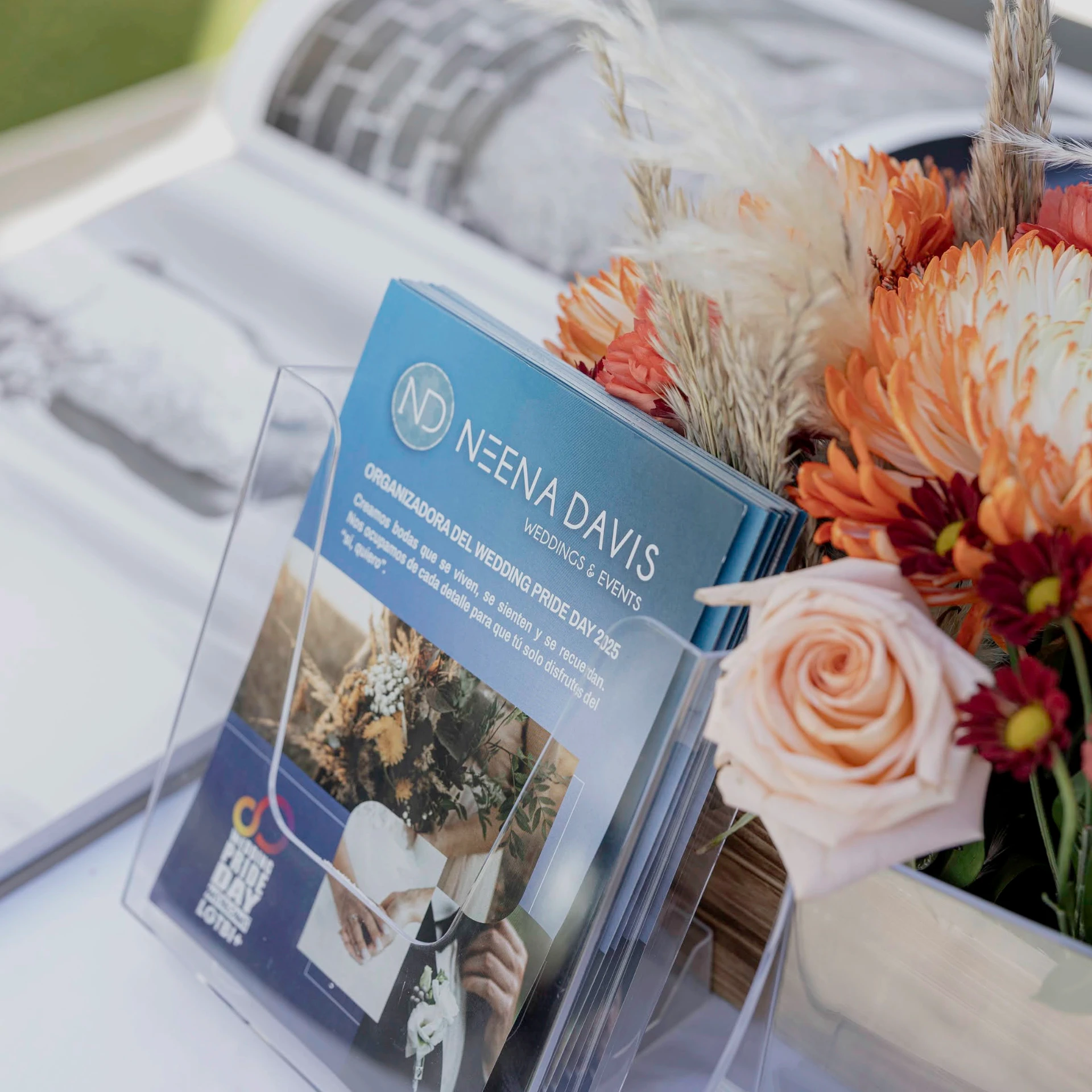 Folletos del evento junto a un arreglo floral